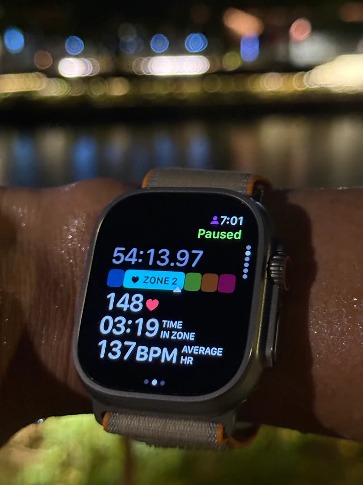 Apple Workout paused during an outdoor run, showing Zone 2, a heart rate of 148 bpm, time in zone and average heart rate