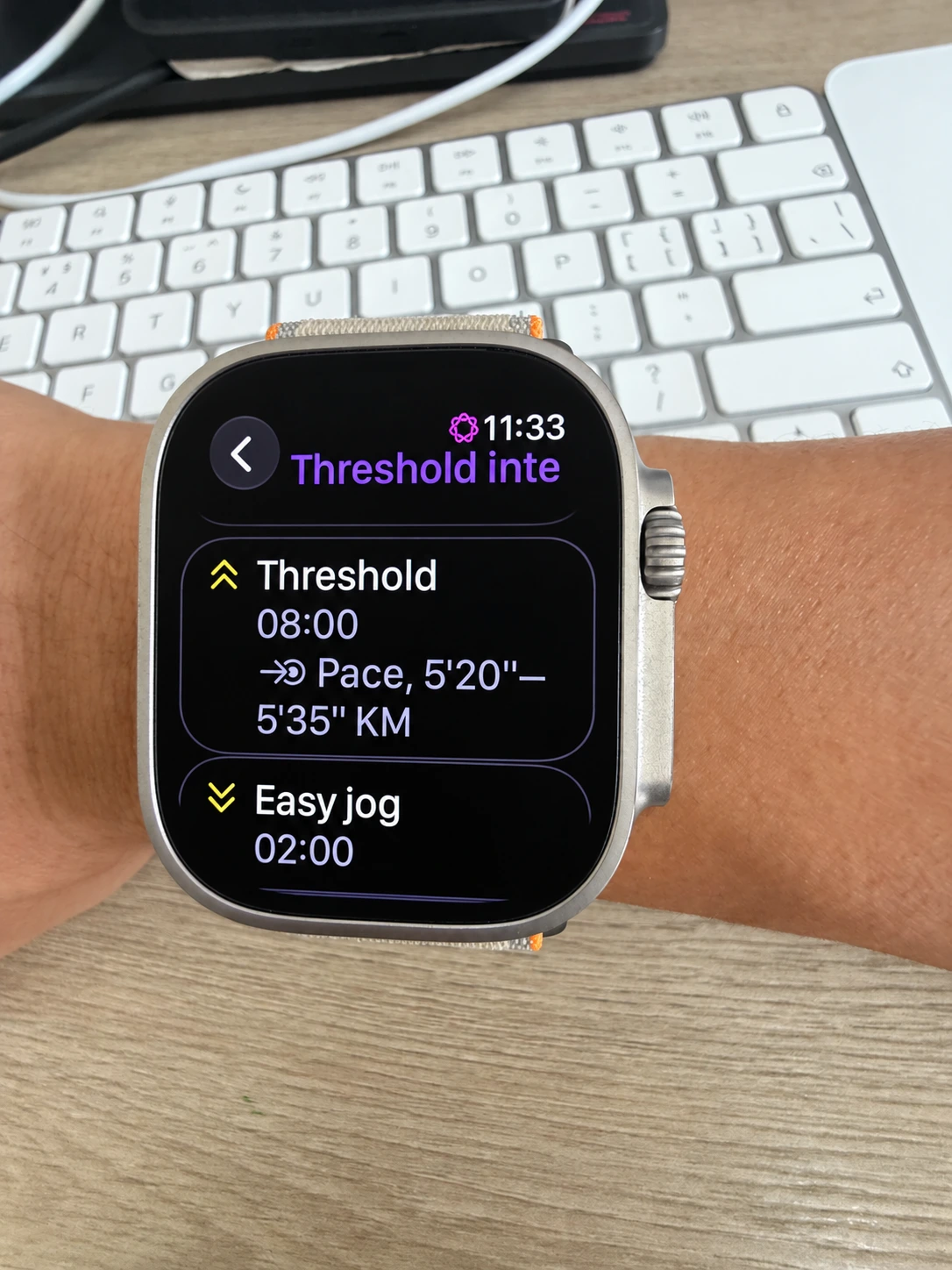 Apple Watch displaying the synced threshold session with an eight-minute effort, pace target and two-minute recovery jog